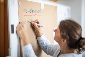 Christine schreibt etwas an ein Whiteboard.